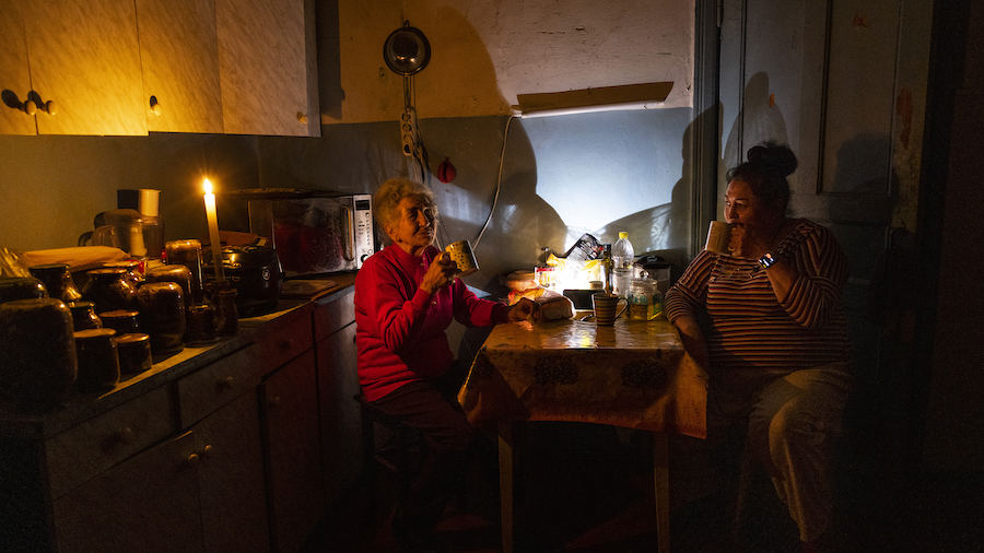 Natalia Zemko, 81, talks with her daughter Lesya as they drink tea in their kitchen during a power ...