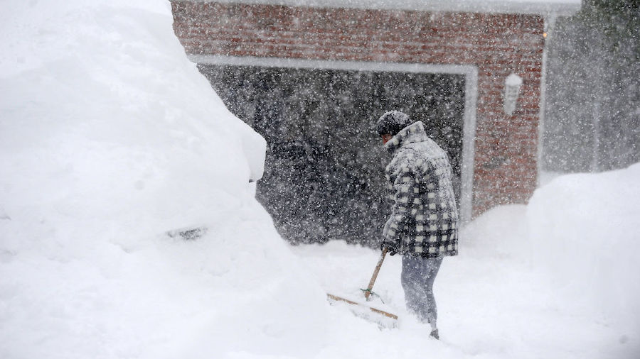Michelle Kucalski digs out her car after intense lake effect snow storm dumped up to four feet of s...