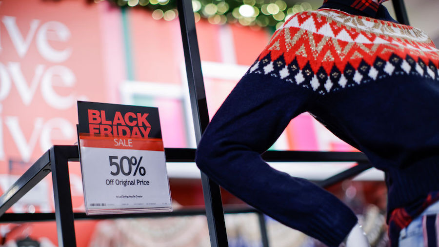 Discount signs are displayed on products at a Macy's store during Black Friday on November 25, 2022...