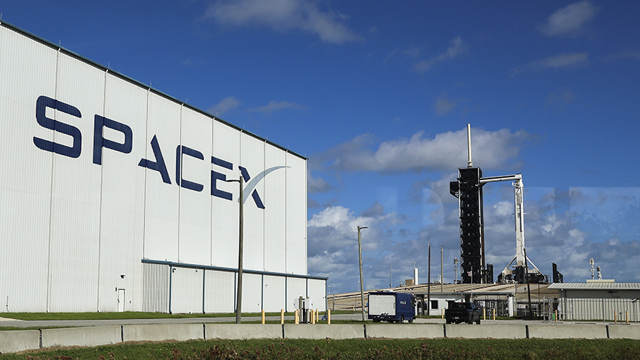 SpaceX’s Falcon 9 rocket with the Dragon spacecraft atop is seen as Space X and NASA....