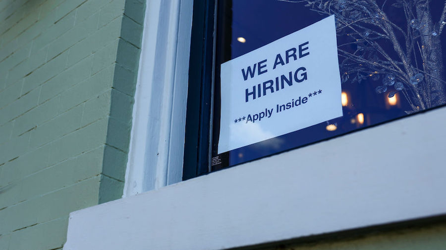 A "We Are Hiring" sign is displayed on a storefront in Georgetown on October 07, 2022 in Washington...