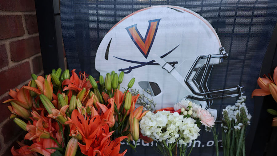 Flowers left outside Scott Stadium at a makeshift memorial for three University of Virginia footbal...