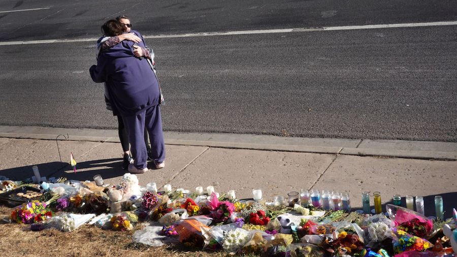 People visit a makeshift memorial near the Club Q nightclub on November 21, 2022 in Colorado Spring...
