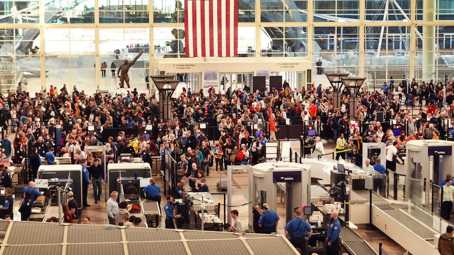 Travelers navigate a security checkpoint at Denver International Airport on November 22, 2022 in De...
