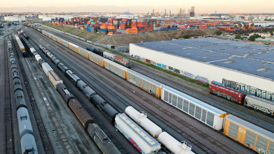 In an aerial view, freight rail cars sit in a rail yard near shipping containers on November 22, 20...