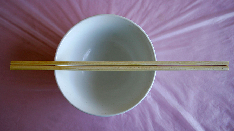 wooden chopsticks on an empty bowl...