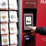 A New York City resident makes a donation at the Giving Machine at New York City’s Rockefeller Center near its iconic Christmas tree in New York City, New York, on Tuesday, November 30, 2021. (Intellectual Reserve, Inc.)