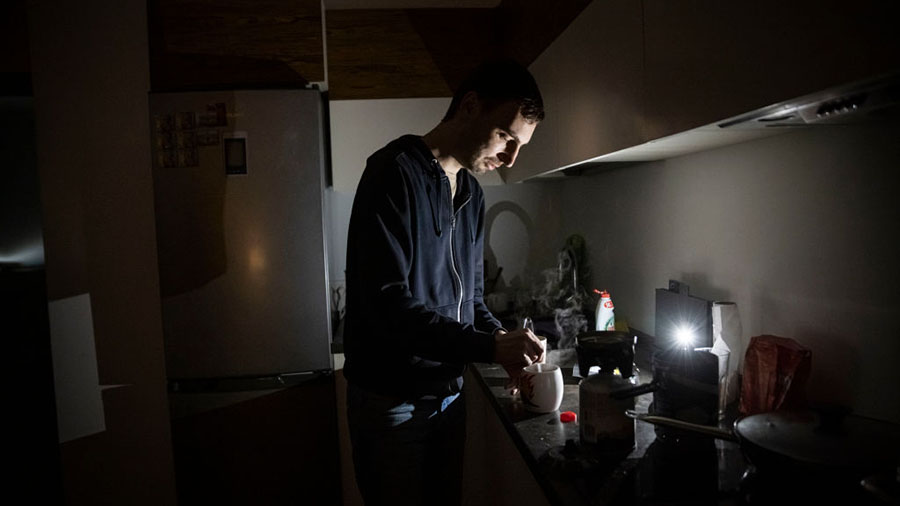 KYIV, UKRAINE - NOVEMBER 06: IT worker Igor, who normally uses en electric hob, makes tea using a c...