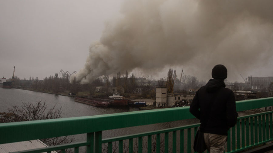 KHERSON, UKRAINE - NOVEMBER 24: A man looks at smoke rising from a Russian strike in the Kherson sh...