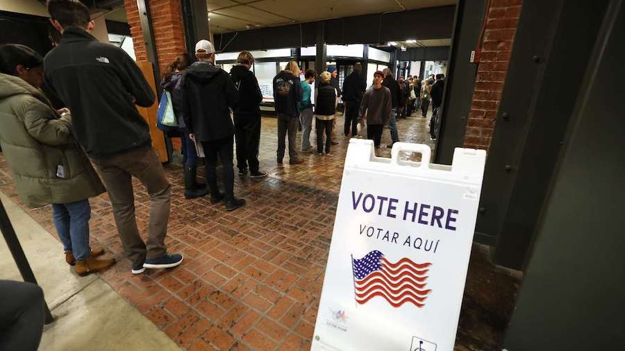 Voters line up at Trolley Square in Salt Lake on Tuesday. Orem splitting from Alpine School Distric...