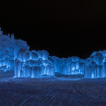 Ice Castle from a distance, lit with blue LED lighting. (Ice Castles)