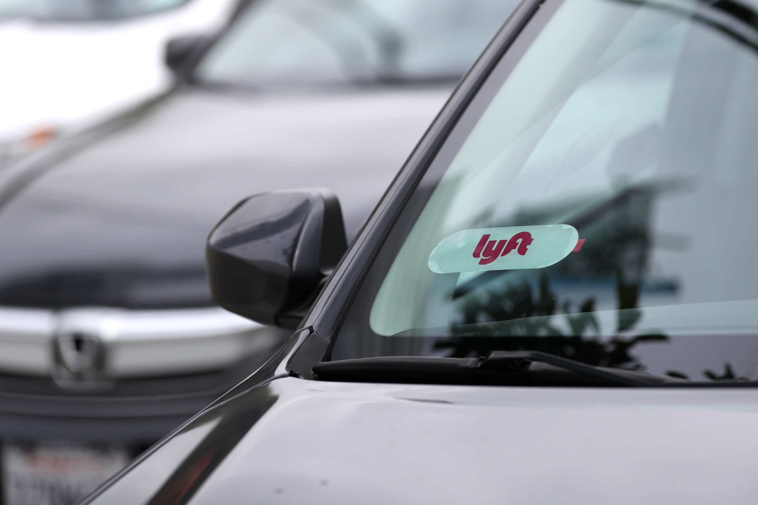 SAN FRANCISCO, CALIFORNIA - MARCH 7: The Lyft logo is displayed on a car on March 7, 2019 in San Fr...