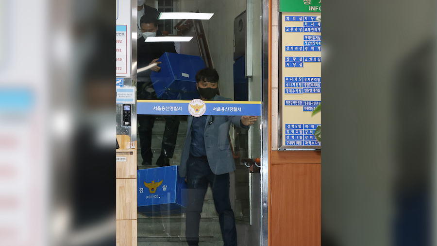 Members of the police special investigative headquarters leave Yongsan Police Station after a raid ...