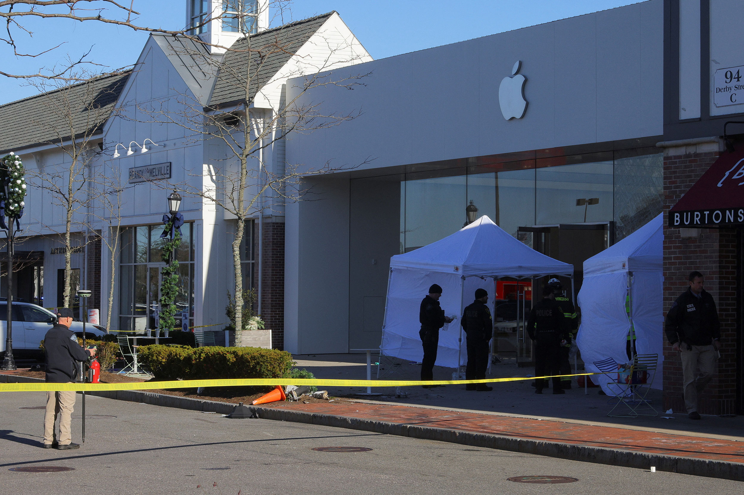 Emergency services personnel attend the scene after a vehicle crashed into an Apple store in Hingha...