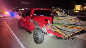 A red Toyota Tundra had damage near the tailgate after being hit by a Jeep Wrangler on the freeway.