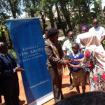 Regional Commissioner hands seedlings to primary school children in Dodoma Tanzania 16 Nov 2022. (Intellectual Reserve, Inc.)
