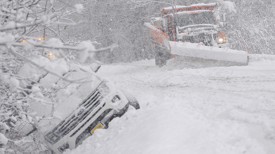 A state plow truck clears the snow along Route 30 in Jamaica, Vt., during a snowstorm on Friday, De...
