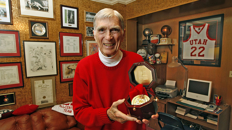 Former Utah All-American basketball player Arnie Ferrin holds his medal from the Basketball Hame of...