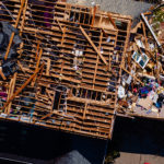 In an aerial view,  a heavily damaged home is seen in the Glenmary subdivision on April 14, 2022 in Louisville, Kentucky. Louisville's Mayor Greg Fischer declared a state of emergency in the city and Jefferson County Public Schools cancelled classes in response to the storm damage. (Photo by Jon Cherry/Getty Images)