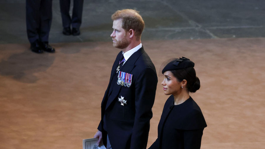 Prince Harry and Meghan, Duchess of Sussex walk as procession with the coffin of Britain's Queen El...