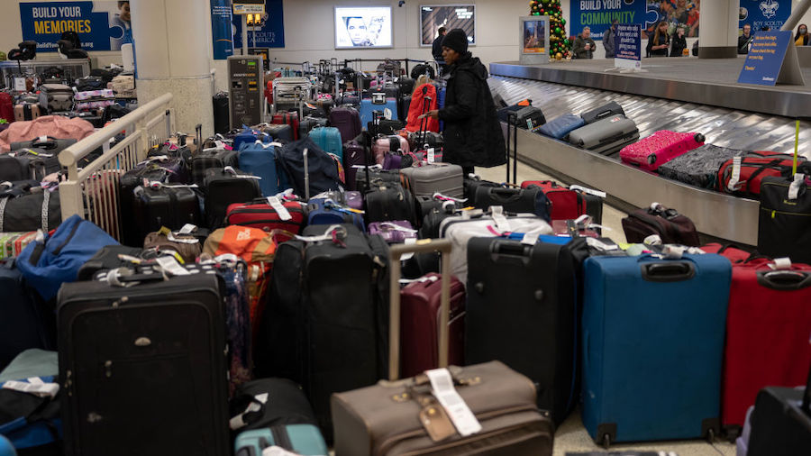 Stranded travelers search for their luggage at the Southwest Airlines Baggage Claim at Midway Airpo...