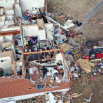 In an aerial view, residents continue to recover from Friday's tornado on December 14, 2021 in Dawson Springs, Kentucky. Multiple tornadoes touched down in several Midwest states late Friday December 10, causing widespread destruction and leaving scores of people dead and injured.  (Photo by Scott Olson/Getty Images)