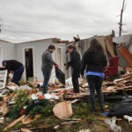Residents search among the debris of a home after it was destroyed from Friday's tornado on December 15, 2021 in Dawson Springs, Kentucky. Multiple tornadoes touched down in several Midwest states late Friday December 10, causing widespread destruction and leaving scores of people dead and injured.  (Photo by Scott Olson/Getty Images)