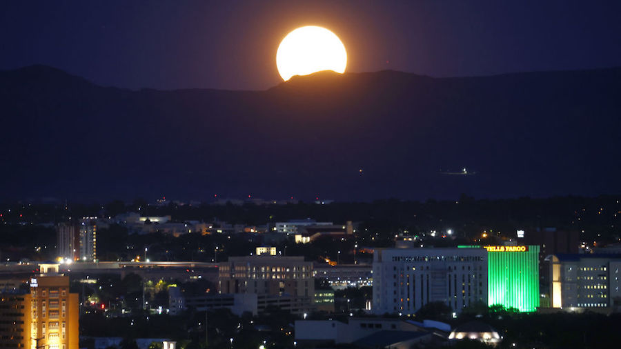 The Sturgeon Moon rises beyond the city on August 11, 2022 in Albuquerque, New Mexico. The Sturgeon...