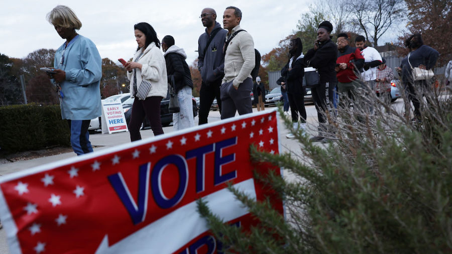 FILE: Residents wait in line to vote early outside a polling station on November 29, 2022 in Atlant...