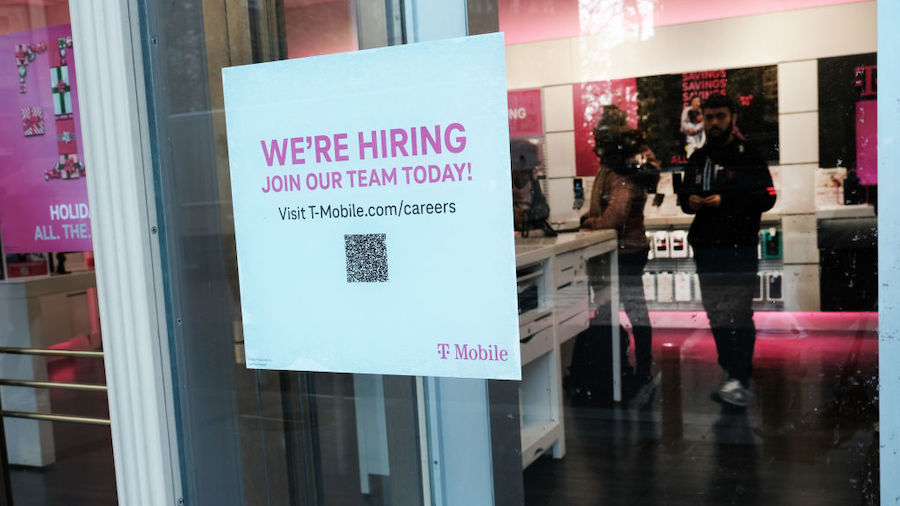 A hiring sign is displayed in a window of a store in Manhattan on December 02, 2022 in New York Cit...
