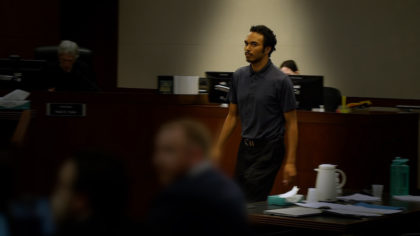Joshua Homer stands in a court room