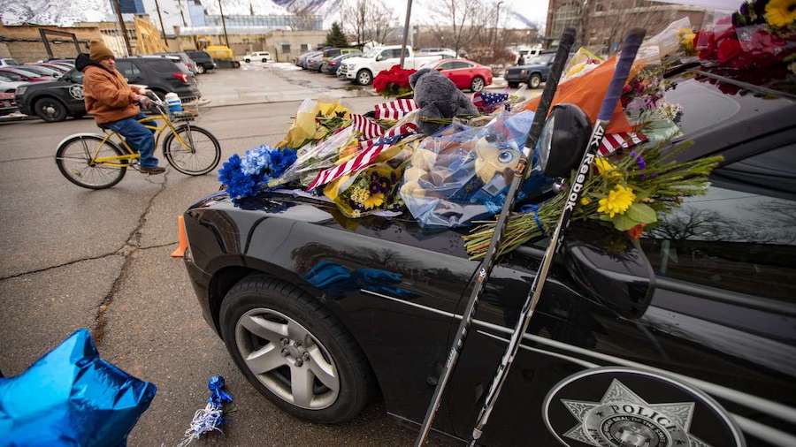 Flowers and other items cover slain Provo police officer Joseph Shinners' patrol car outside Provo ...