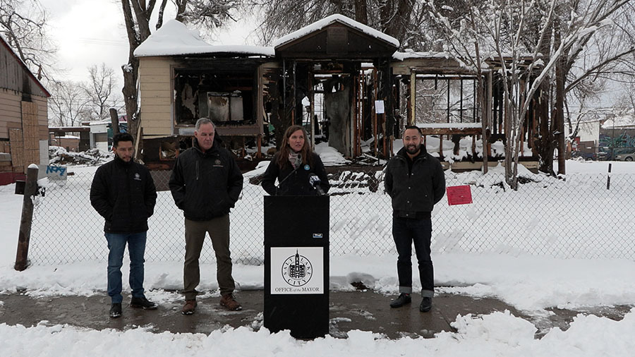Salt Lake City Mayor Erin Mendenhall and other city officials in front of one of the burned-down pr...