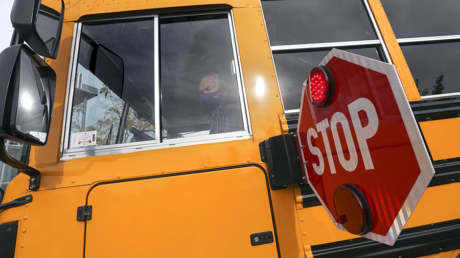 A school bus with extended stop sign...