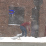 Jared Briggs shovels snow off of the sidewalk in front of his insurance business. (Mark Wetzel, KSL TV)