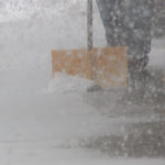 Jared Briggs shovels snow off of the sidewalk in front of his insurance business. (Mark Wetzel, KSL TV)