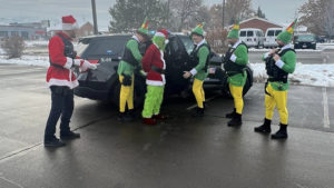 officers dressed as elves put handcuffs on the grinch