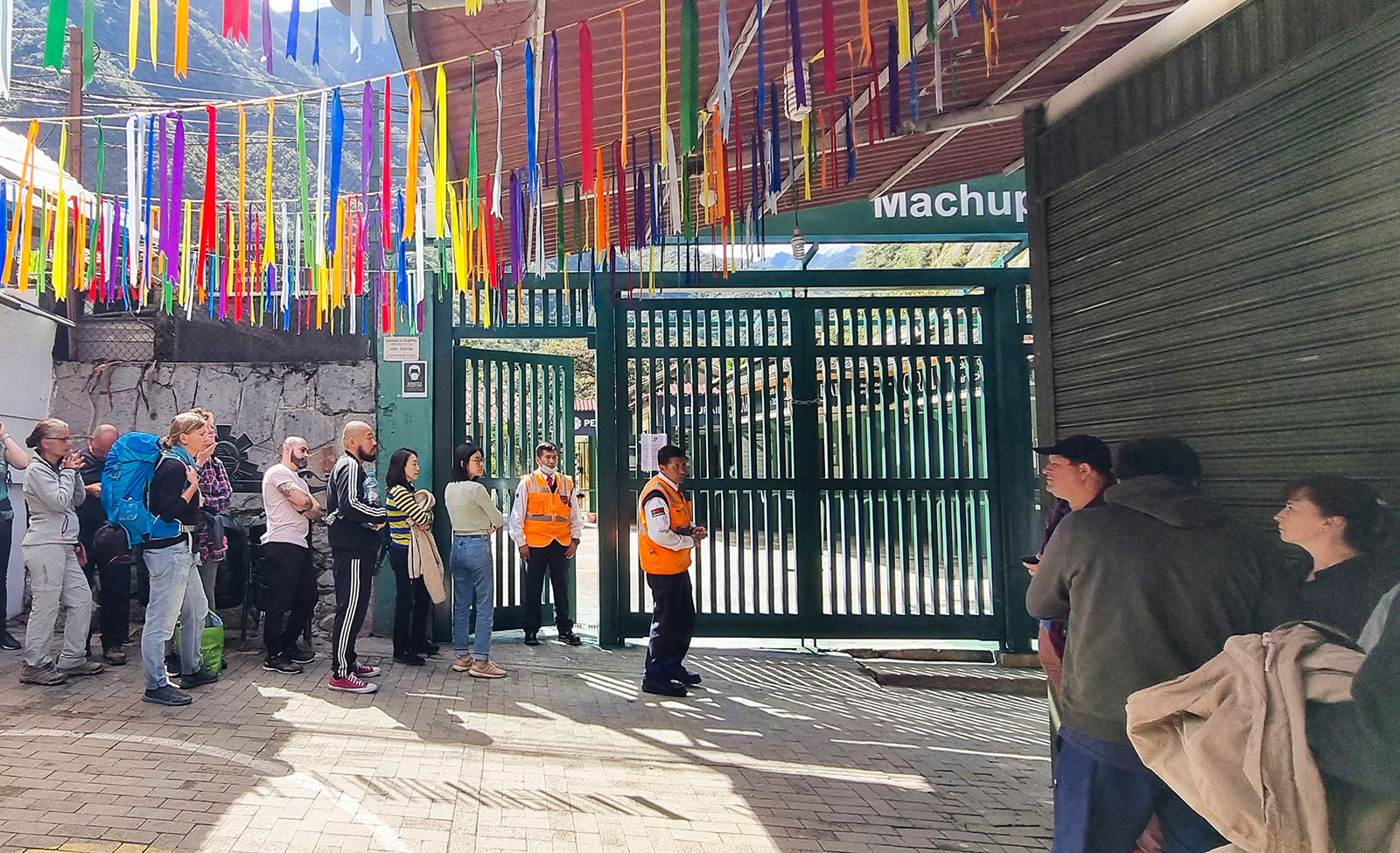 Stranded tourists queue at the train terminal in the town of Machu Picchu, Perus main tourist attra...