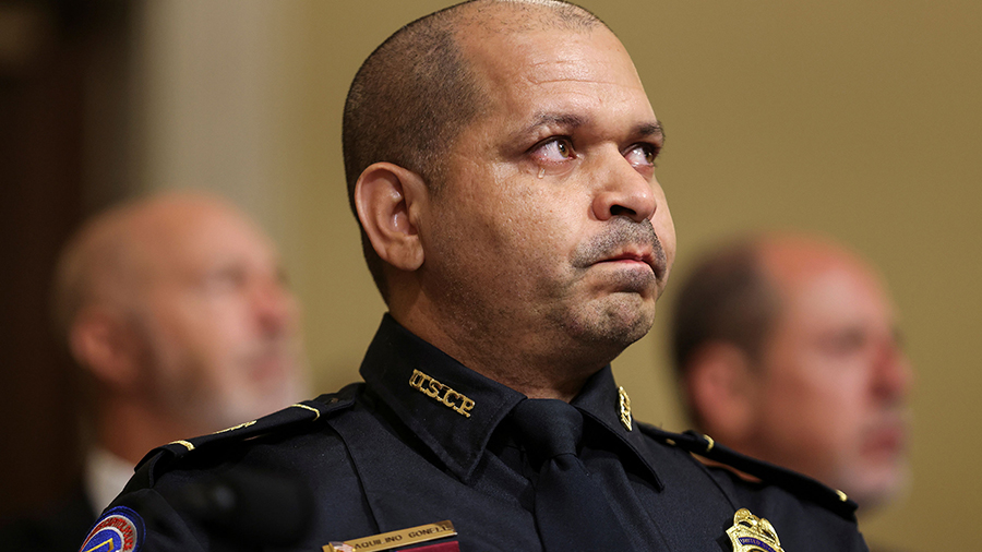U.S. Capitol Police officer Sgt. Aquilino Gonell becomes emotional as he testifies before the House...