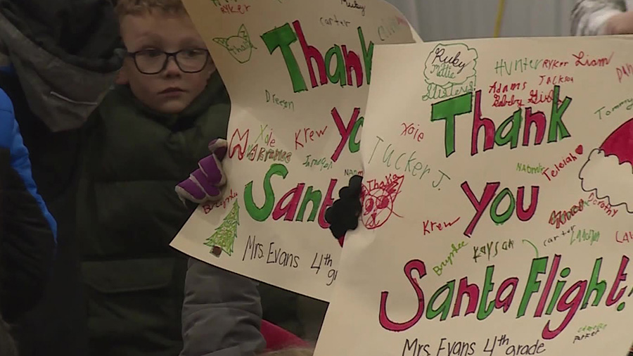 children hold signs that say thank you...