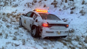 A UHP car is on the side of the road with damage.