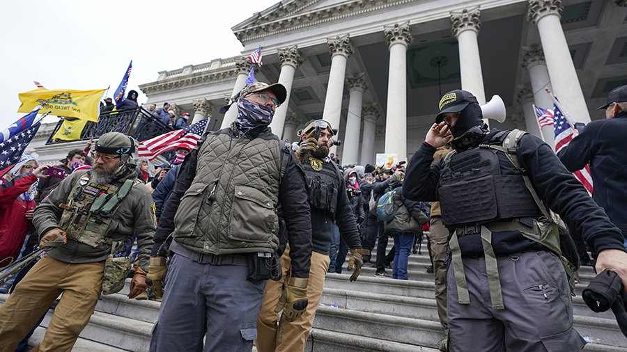 FILE - Members of the Oath Keepers extremist group stand on the East Front of the U.S. Capitol on J...