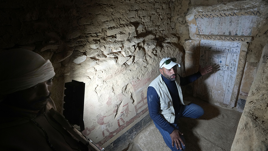 An Egyptian archeologist speaks at a recently discovered tomb dated to the Old Kingdom, 2700–2200...