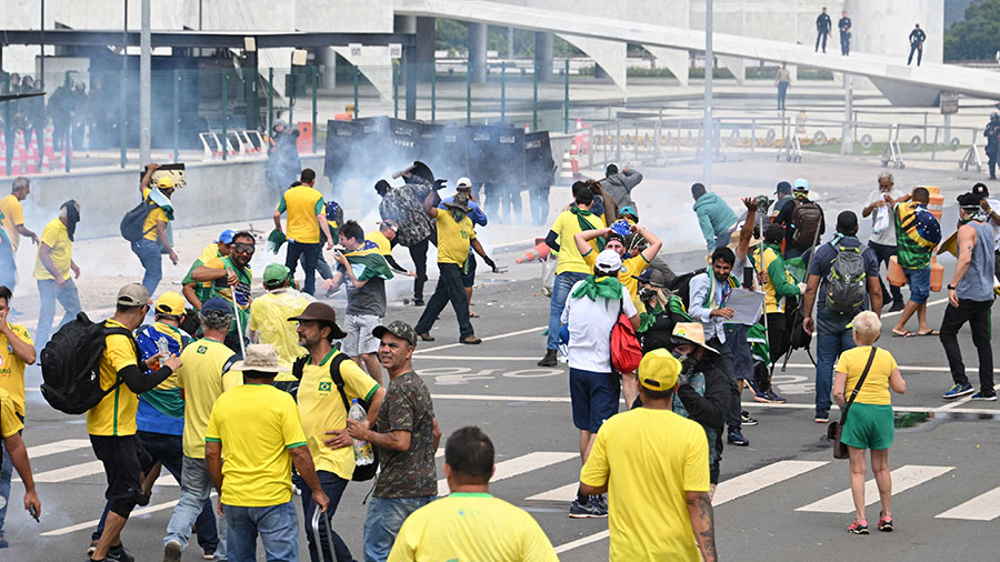 Supporters of Brazilian former President Jair Bolsonaro clash with the police during a demonstratio...