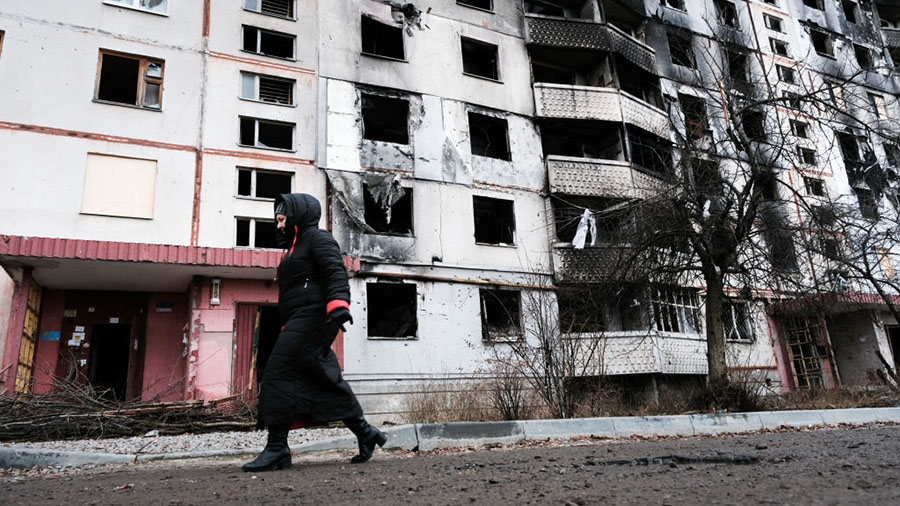 KYIV, UKRAINE - JANUARY 03: People walk through a neighbourhood destroyed by the Russians on the ou...