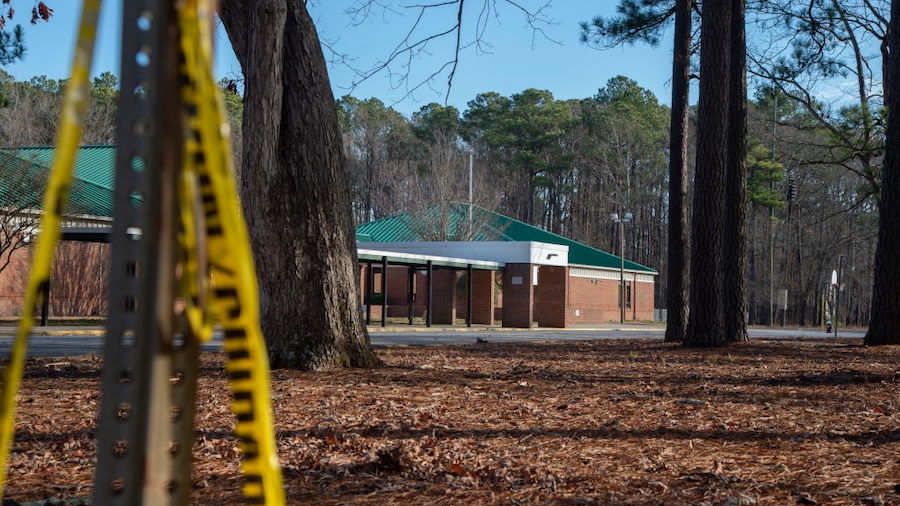 Police tape hangs from a sign post outside Richneck Elementary School following a shooting on Janua...