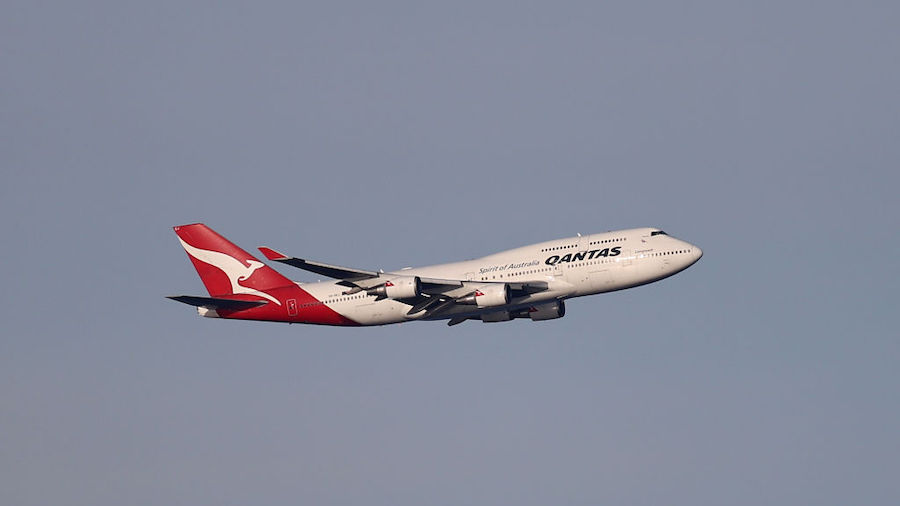 A Qantas Boeing 747-400, registration VH-OEJ,  passes over Sydney's Eastern Suburbs as it departs S...
