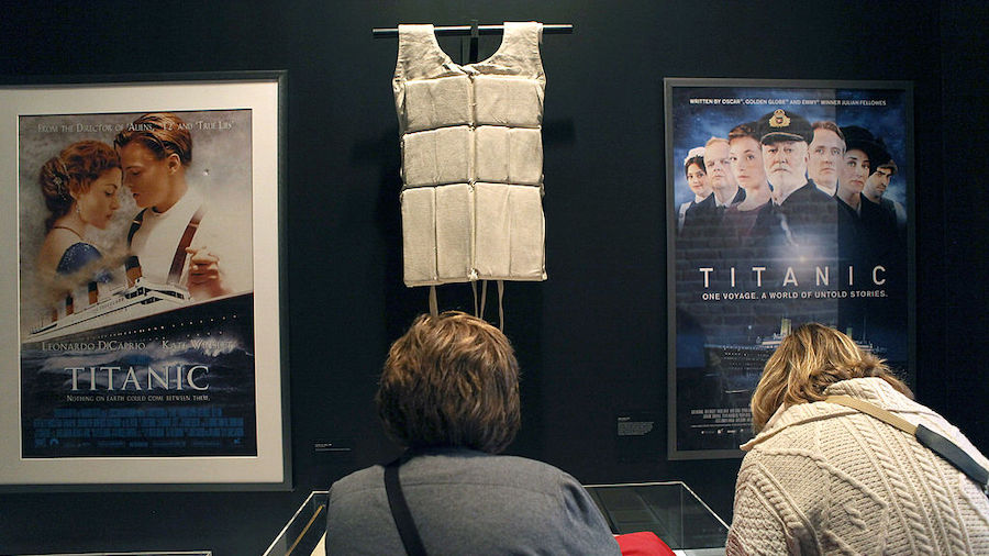 A life vest and posters from the 1997 movie "Titanic" hang on display at the opening of the "Titani...