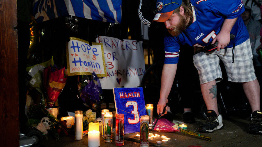 Buffalo Bills fan Dustin Peters attends a candlelight vigil for Buffalo Bills safety Damar Hamlin a...