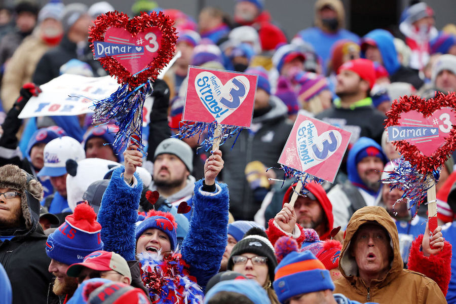 Buffalo Bills fans hold signs in support of Buffalo Bills safety Damar Hamlin during a game against...